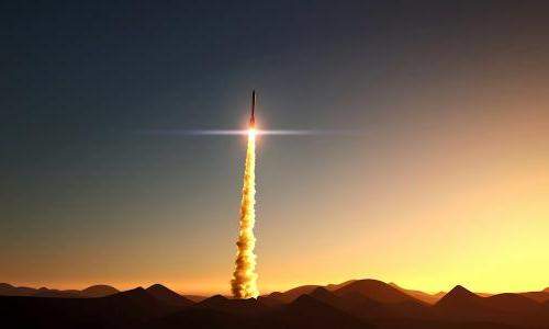 Missile launch above a mountain range at sunrise